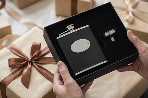 Black leather hip flask with pouring funnel in its gift box